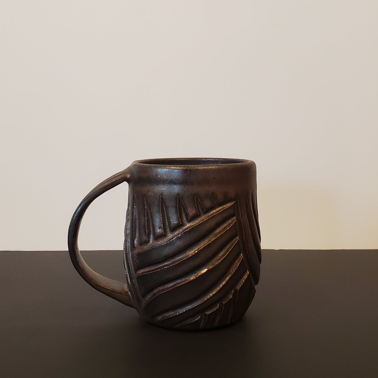 A Carved Bronzed Ceramic Mug