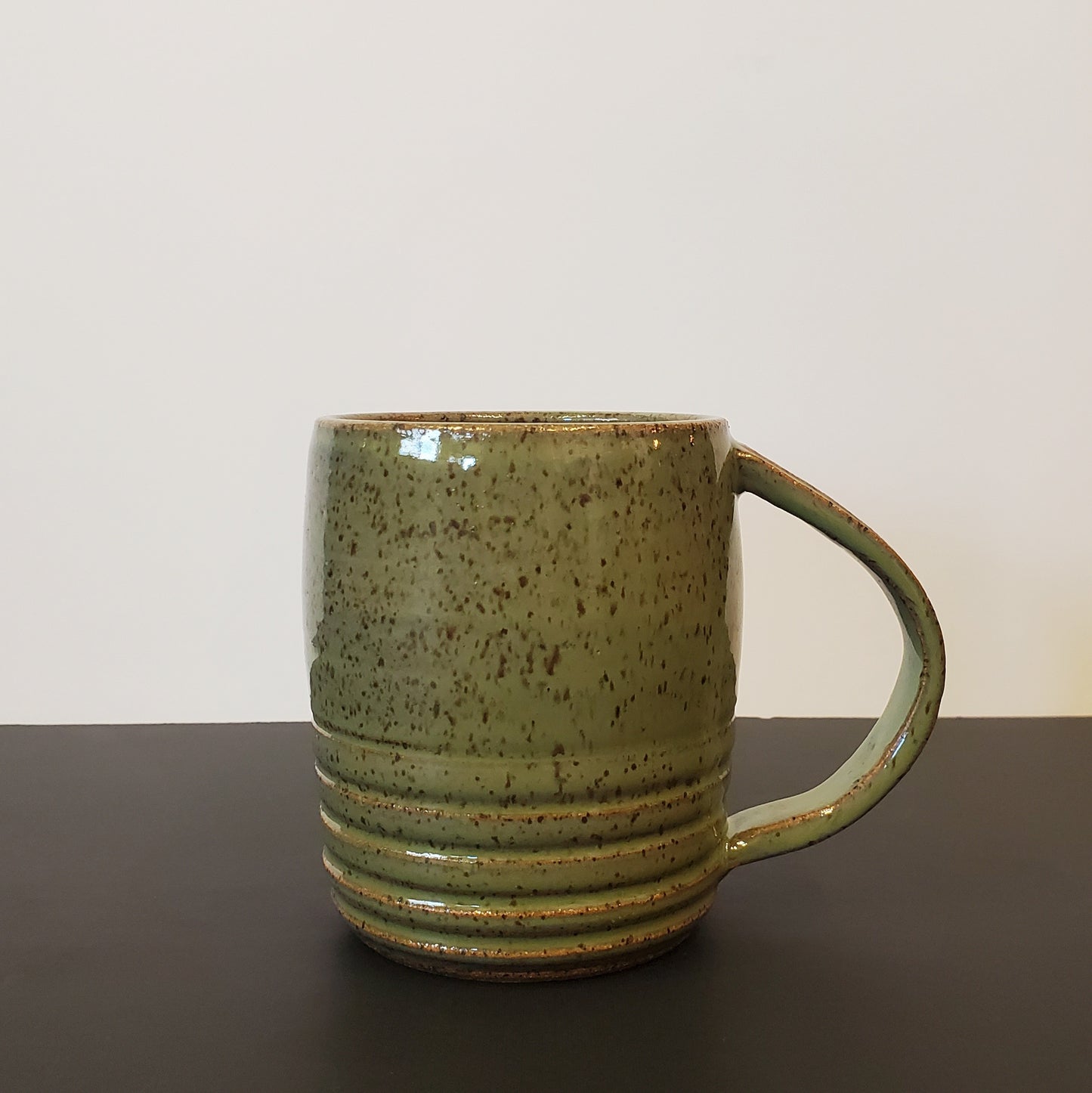 An Olive Green Speckled Ceramic Mug