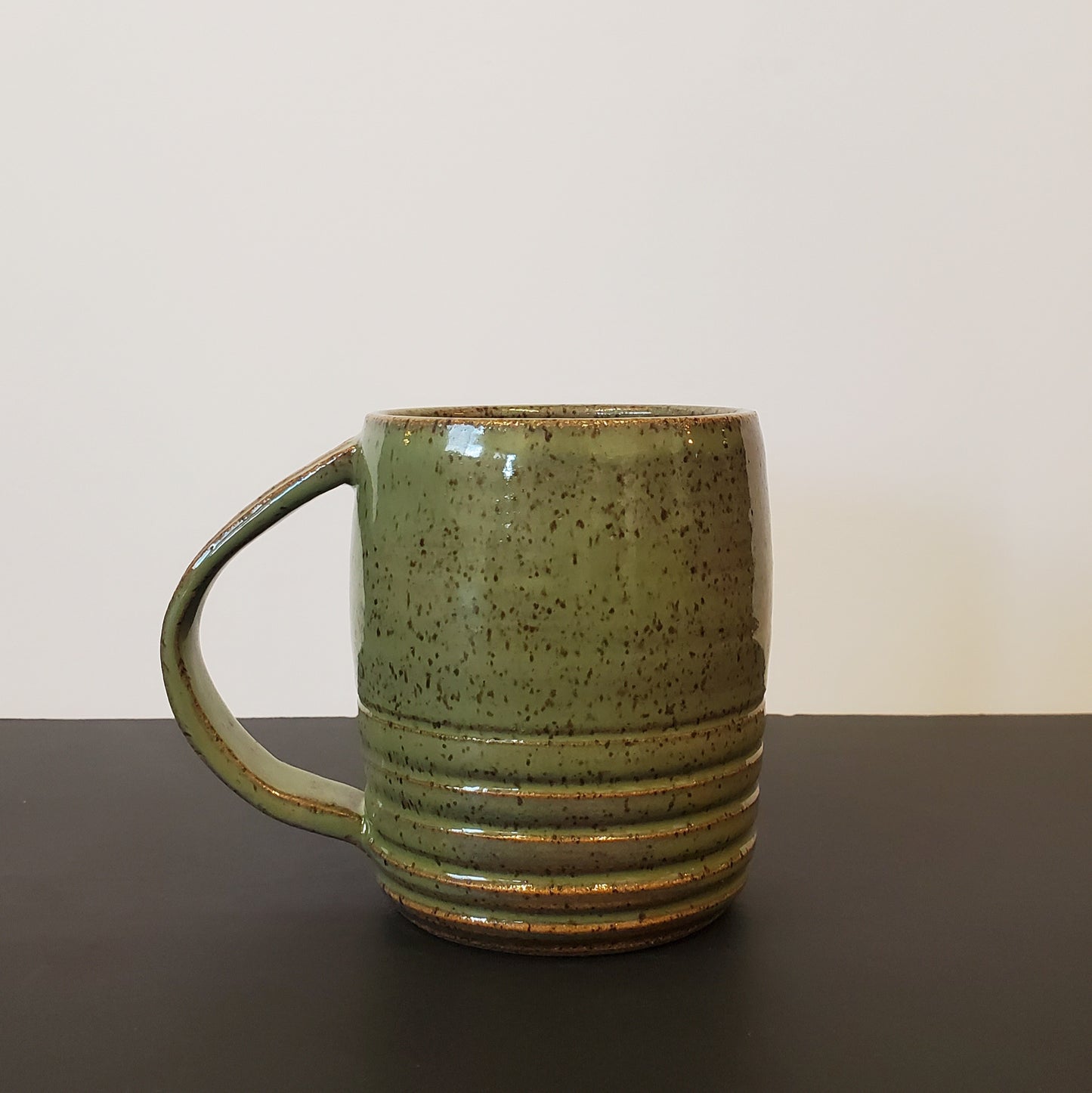 An Olive Green Speckled Ceramic Mug