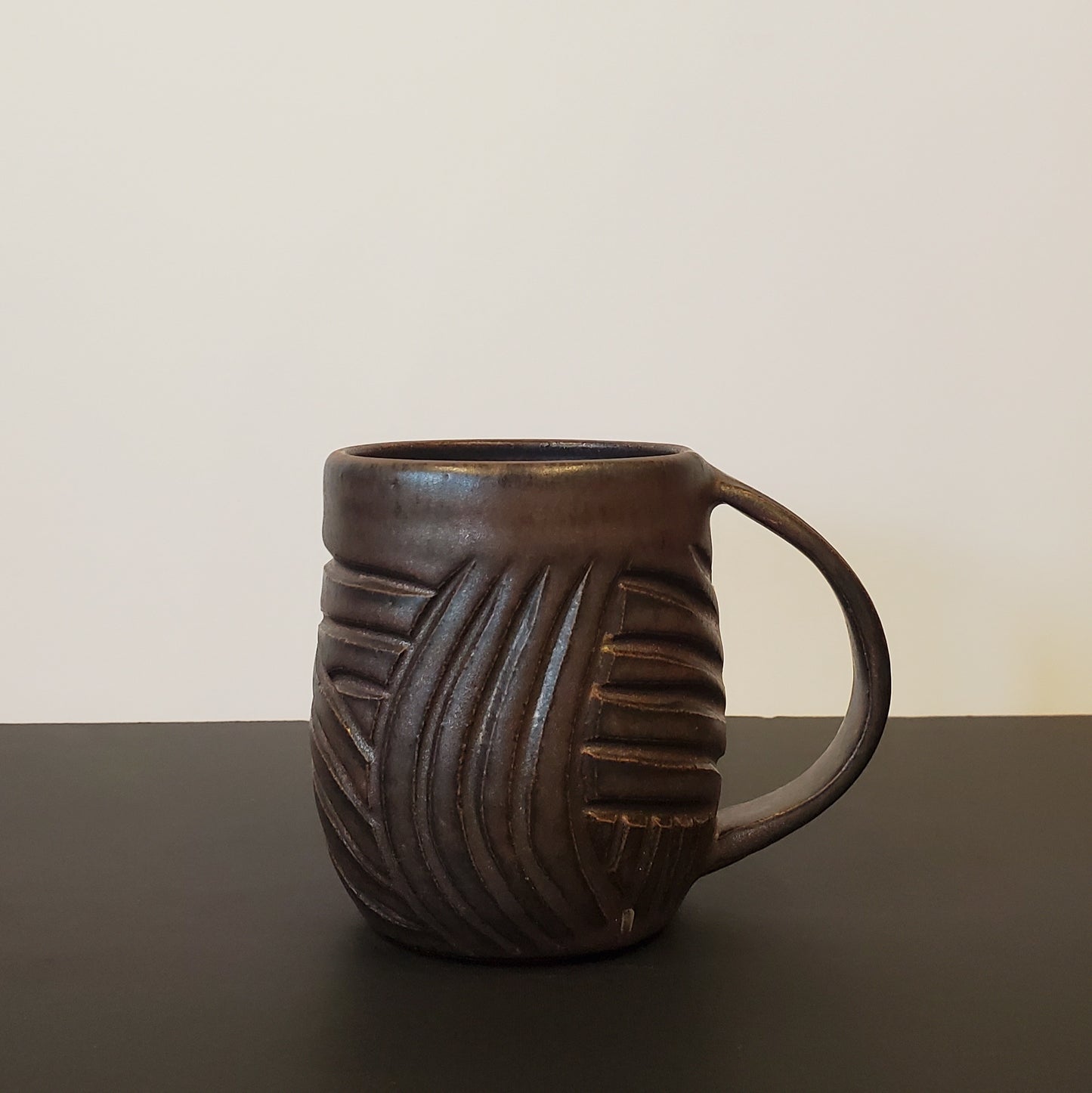 A Carved Bronzed Ceramic Mug